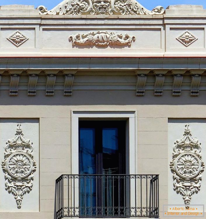 Arhitektonski elementi u obliku štukature iz gipsa ukrašavaju fasadu kuće u stilu Empire. Zamišljeni, zamršeni obrasci čine izvanjskim neobičnim.