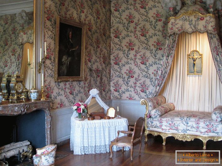 Šareni ukras zidova u skladu je s presvlakom sofe i nadstrešnice nad njim. Barokni salon s velikim kaminom izvrsna je ideja za seosku kuću.