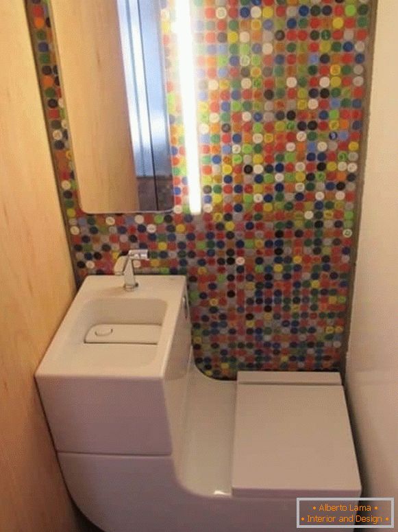 Mali WC s modernim kombiniranim toaletom i svijetlim mozaikom