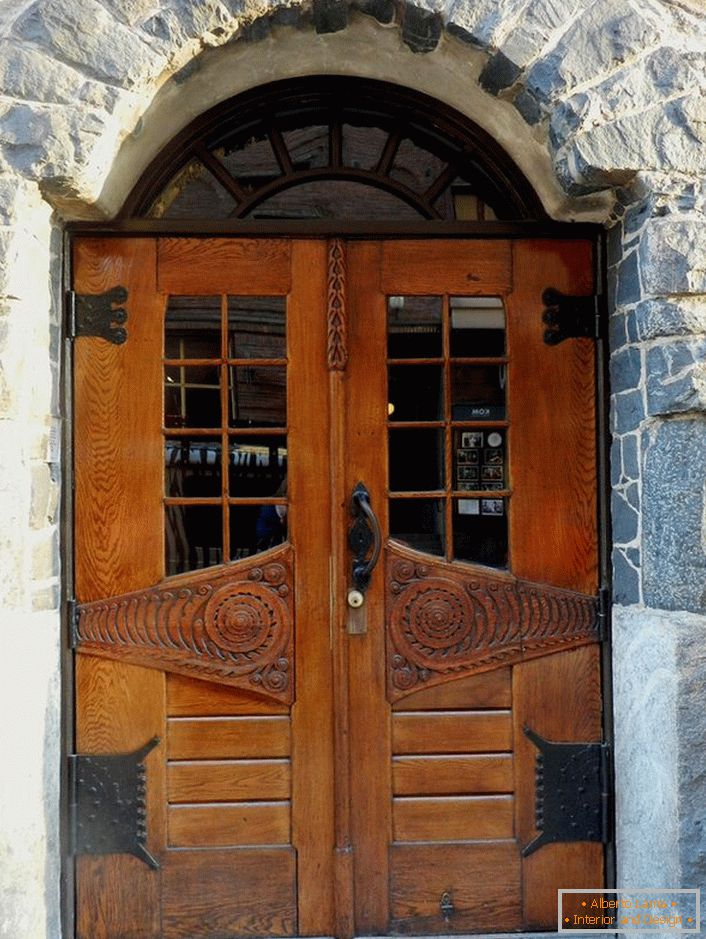 Vrata u secesijskom stilu ukrašavaju ulazna vrata vikendice s fasadom od prirodnog kamena. 